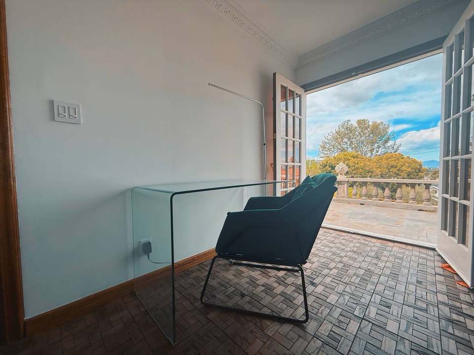 Glass desk and chair by French doors, a quiet downstairs spot for quick work
